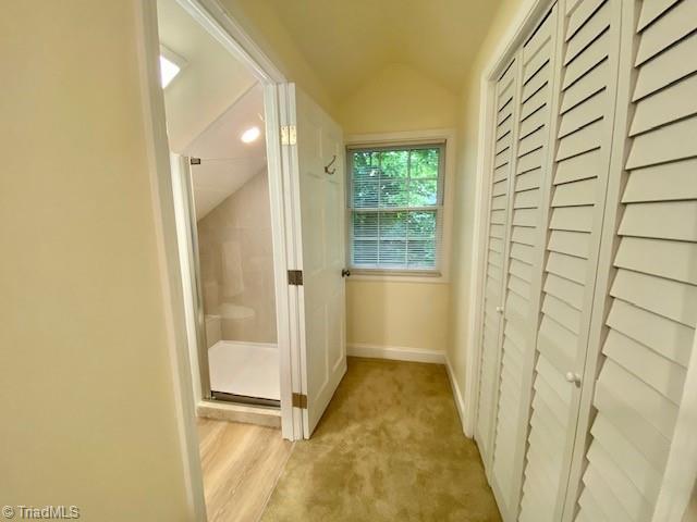 305 W Avondale Dr, Greensboro, NC 27403 - hallway featuring lofted ceiling, baseboards, and light colored carpet
