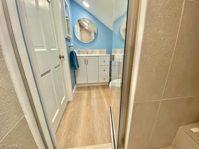305 W Avondale Dr, Greensboro, NC 27403 - bathroom featuring vanity, wood finished floors, and toilet