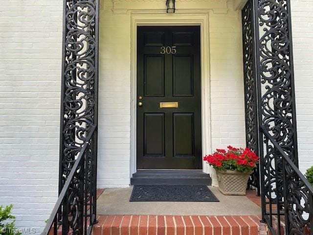 305 W Avondale Dr, Greensboro, NC 27403 - doorway to property with brick siding