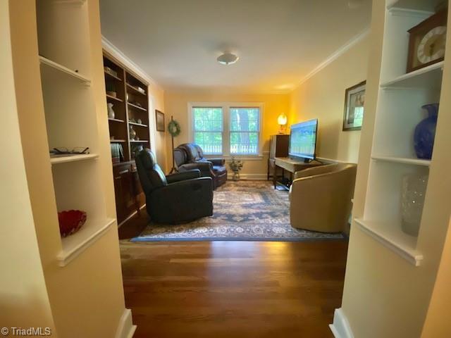 305 W Avondale Dr, Greensboro, NC 27403 - living area featuring wood finished floors, crown molding, and built in features
