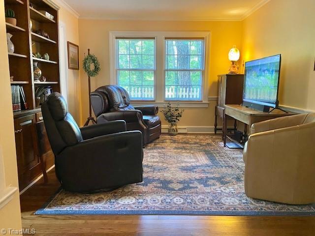 305 W Avondale Dr, Greensboro, NC 27403 - living room featuring ornamental molding, wood finished floors, and baseboards