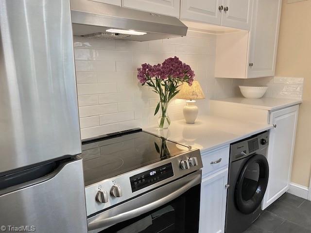 305 W Avondale Dr, Greensboro, NC 27403 - washroom with washer / dryer, dark tile patterned flooring, and baseboards