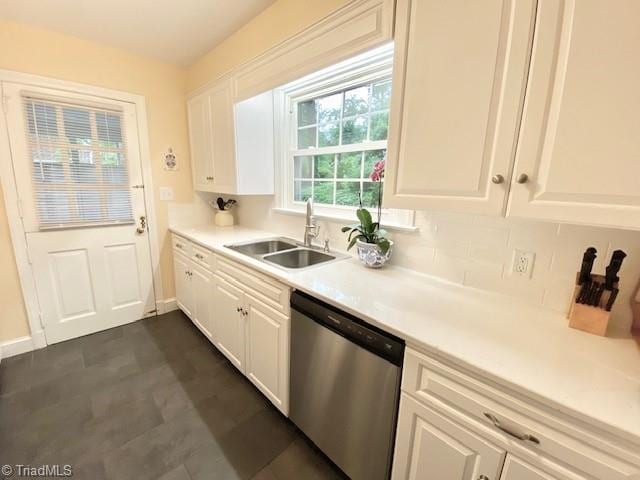 305 W Avondale Dr, Greensboro, NC 27403 - kitchen with stainless steel dishwasher, a sink, white cabinetry, and light countertops
