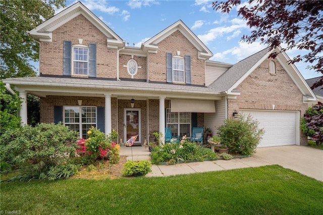 traditional-style home with covered porch, a garage, brick siding, a front lawn, and concrete driveway