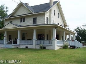 back of house with a lawn and a porch