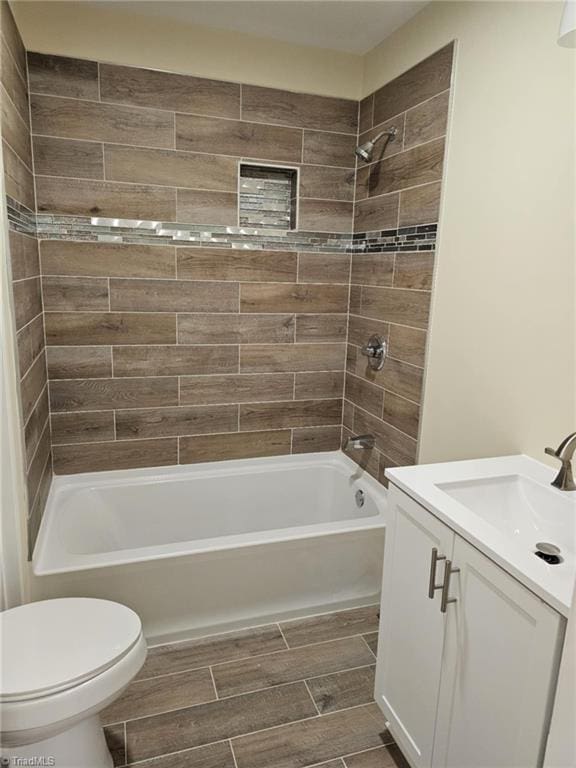 full bath featuring  shower combination, wood tiled floor, toilet, and vanity