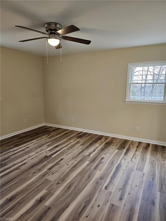 empty room with wood finished floors and baseboards