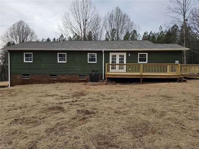 back of house with central air condition unit and a deck