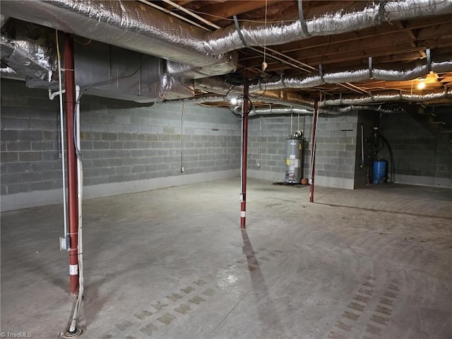 unfinished basement featuring gas water heater