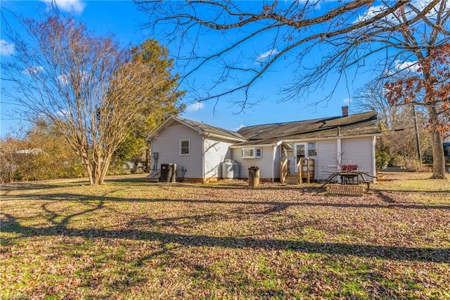 back of house with a lawn