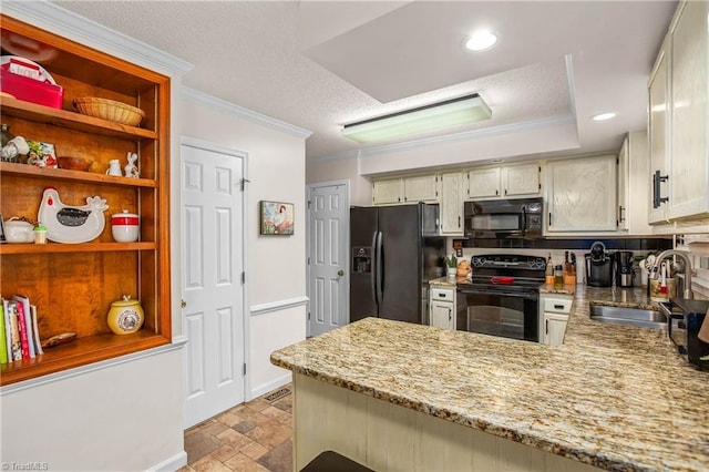kitchen with a sink, light stone counters, black appliances, a peninsula, and ornamental molding