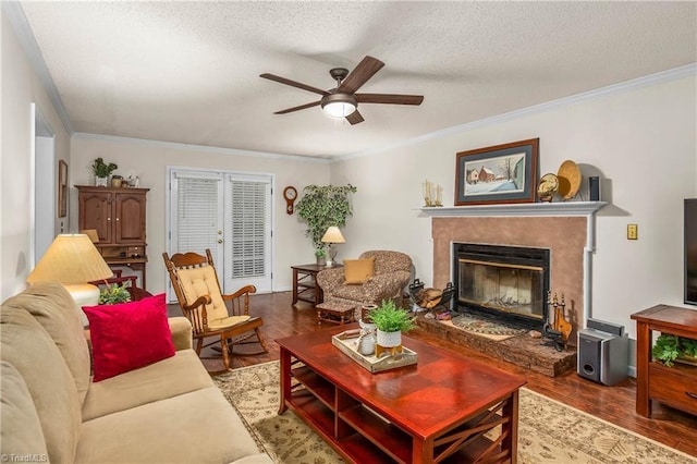 living room featuring a ceiling fan, a textured ceiling, wood finished floors, and a premium fireplace