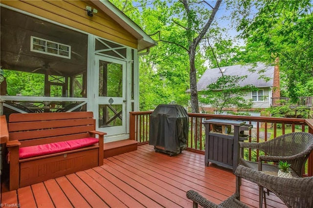 deck with grilling area and a sunroom
