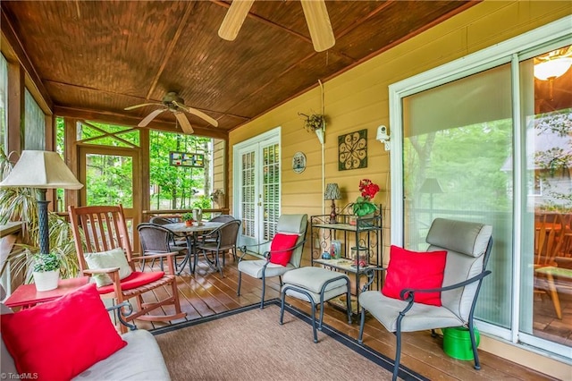 sunroom featuring ceiling fan, french doors, and outdoor dining space