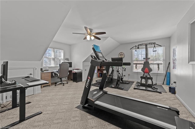 exercise area featuring lofted ceiling, ceiling fan, carpet floors, and baseboards