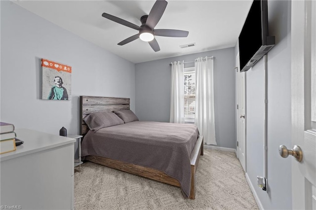 bedroom featuring light colored carpet, visible vents, ceiling fan, and baseboards