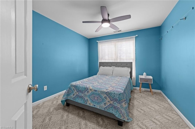 carpeted bedroom with visible vents, baseboards, and ceiling fan