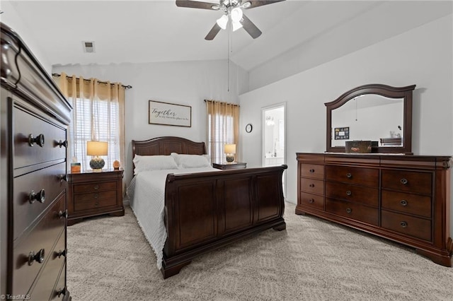 bedroom with visible vents, ensuite bathroom, a ceiling fan, light carpet, and vaulted ceiling