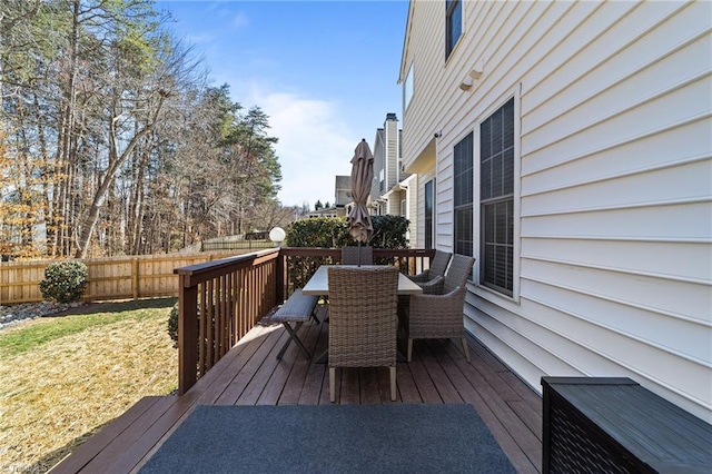 deck featuring outdoor dining space and fence