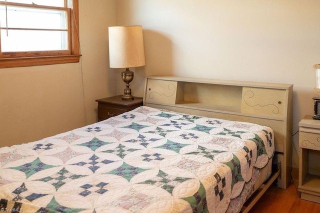 bedroom featuring wood finished floors