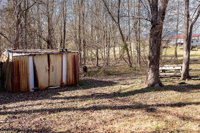 view of yard with a storage shed and an outbuilding