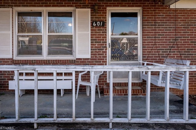 view of exterior entry featuring brick siding