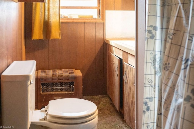 bathroom featuring toilet and wooden walls