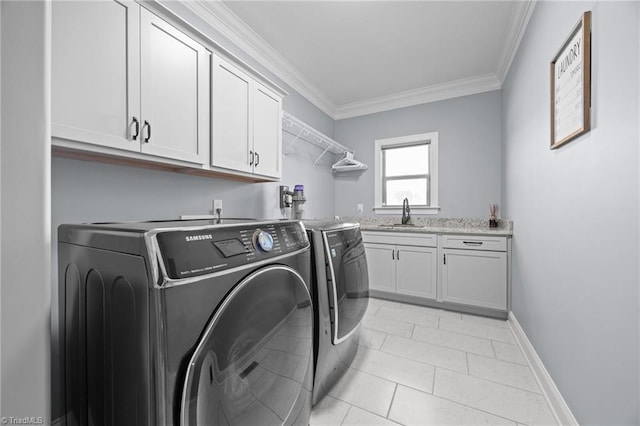 washroom with washer and clothes dryer, cabinet space, crown molding, light tile patterned floors, and baseboards