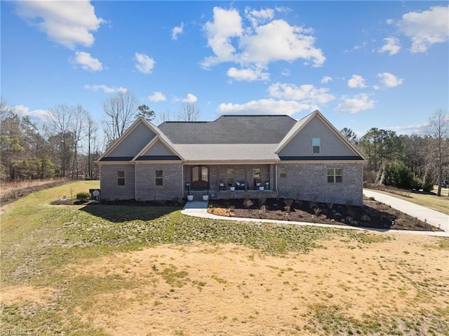 view of front facade featuring a front lawn and covered porch