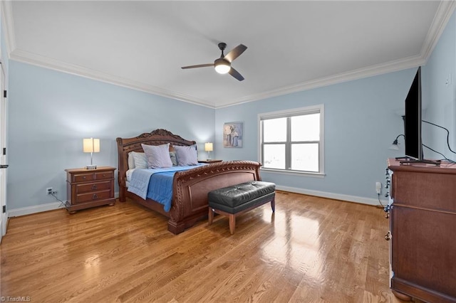 bedroom with ceiling fan, crown molding, light wood-type flooring, and baseboards