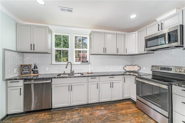 525 Carolina Blvd, Salisbury, NC 28146 - kitchen with appliances with stainless steel finishes, dark stone countertops, backsplash, dark wood-style floors, and recessed lighting