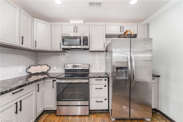 525 Carolina Blvd, Salisbury, NC 28146 - kitchen featuring appliances with stainless steel finishes, dark wood-style flooring, dark stone counters, decorative backsplash, and recessed lighting