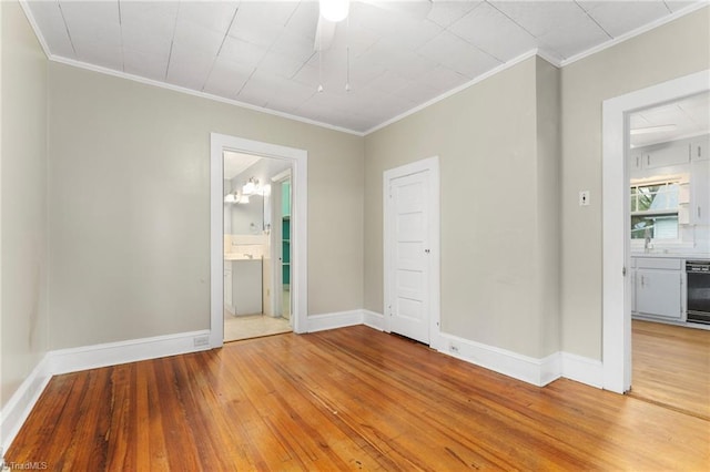 unfurnished bedroom with wood-type flooring, ornamental molding, and baseboards