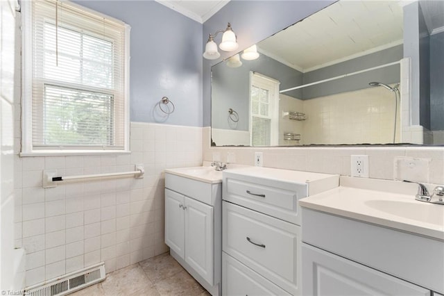 bathroom with vanity, tile patterned floors, crown molding, visible vents, and tile walls