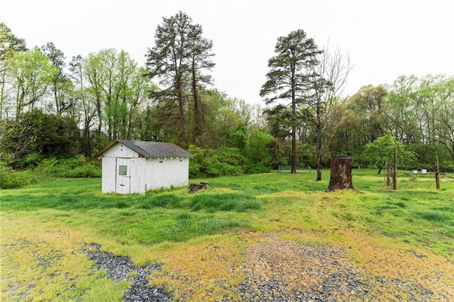 view of yard featuring an outbuilding and a shed