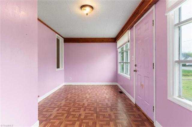 interior space with ornamental molding and baseboards