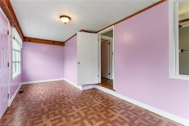 unfurnished room with visible vents and baseboards