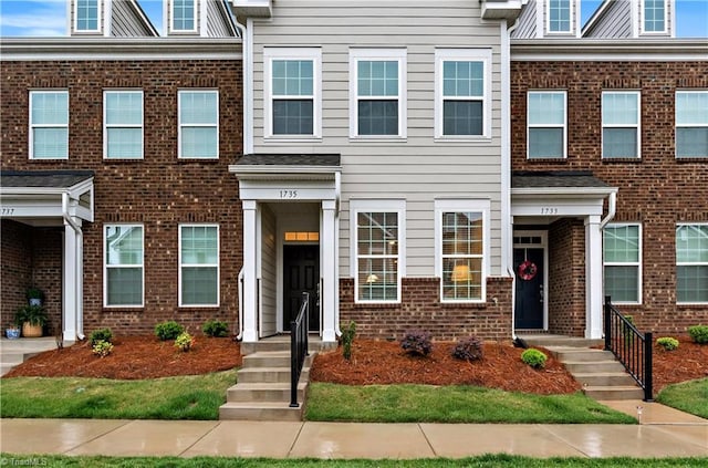 view of property featuring brick siding