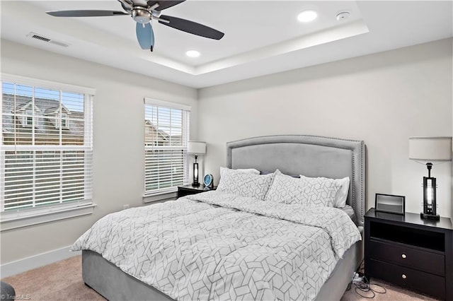 bedroom with a raised ceiling, carpet, recessed lighting, baseboards, and ceiling fan