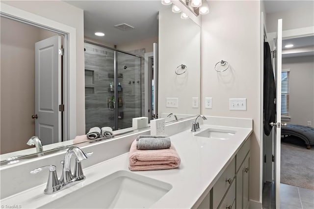 bathroom with a shower stall, tile patterned floors, double vanity, and recessed lighting