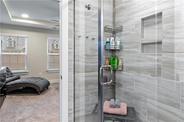 full bathroom featuring a shower stall, a raised ceiling, and recessed lighting