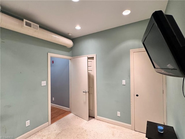 220 Market St Unit 110, Greensboro, NC 27401 - unfurnished bedroom featuring carpet flooring, recessed lighting, and baseboards