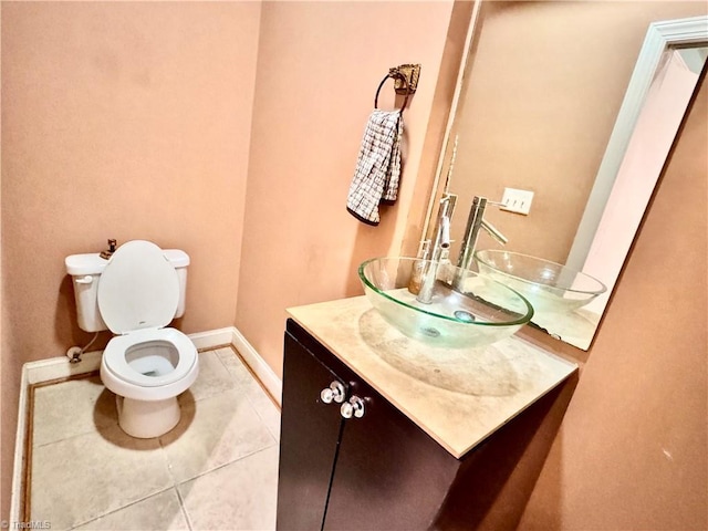 220 Market St Unit 110, Greensboro, NC 27401 - bathroom with baseboards, vanity, toilet, and tile patterned flooring