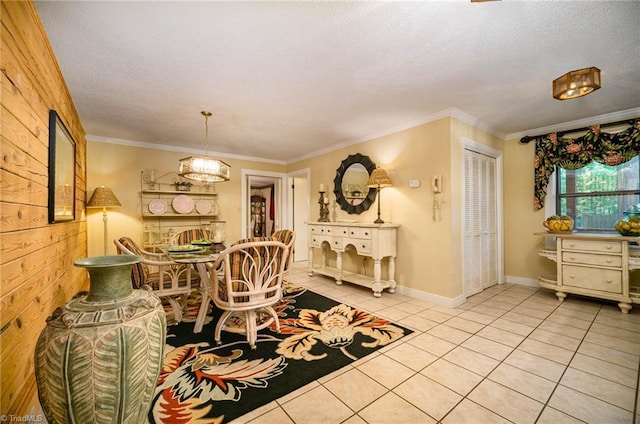 tiled dining room with crown molding, wooden walls, and a textured ceiling