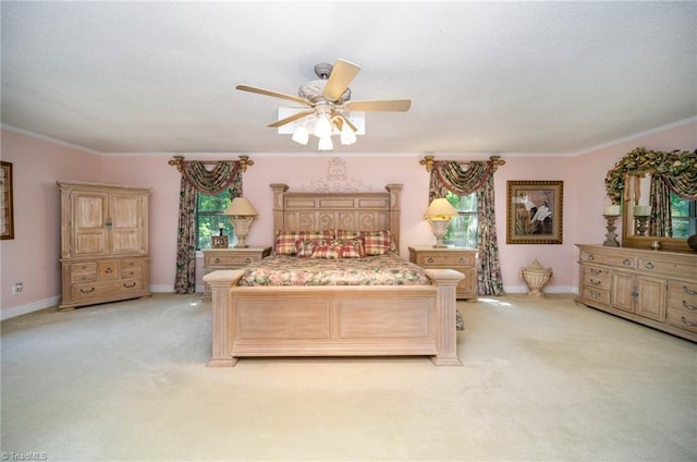 bedroom with light carpet, crown molding, and ceiling fan