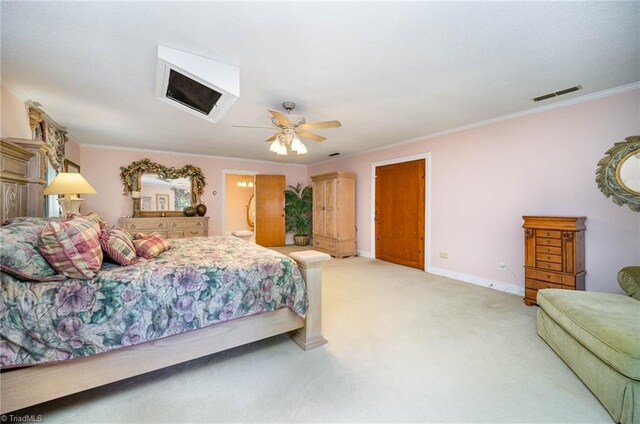 bedroom featuring ceiling fan, light colored carpet, and ornamental molding