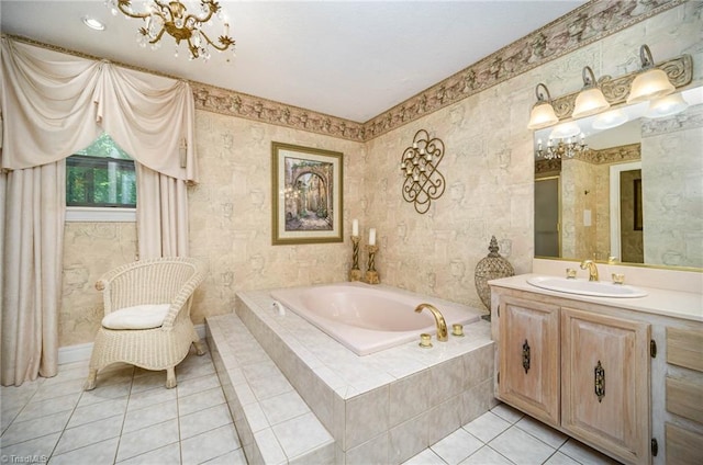 bathroom with an inviting chandelier, tile flooring, large vanity, and tiled tub