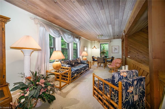 carpeted living room featuring wood ceiling