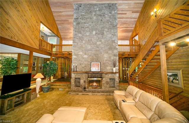 living room with high vaulted ceiling, wood walls, a fireplace, and wood ceiling