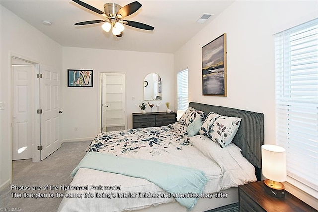 carpeted bedroom featuring visible vents, baseboards, and ceiling fan
